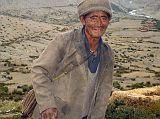 6 3 Old Man With Whip Yulok Village Near Kharta As we walked through the Yulok village we heard a loud bullet-like sound. We veered towards the sound and found a man dressed in all gray from the hat on his head to his feet cracking a whip. He smiled warmly and Chris motioned for him to demonstrate his whipping technique while we took photos. He obliged and laughed heartily as he expertly snapped the whip a couple of times. I patted him on the back as we waved goodbye.